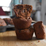 bran and prune muffins in a stack.