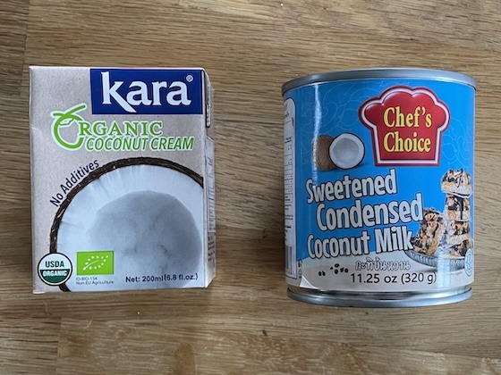 A carton of coconut cream next to a can of sweetened condensed coconut milk.