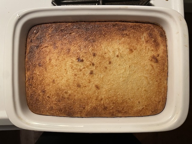 Baked cassava cake in a rectangular pan.