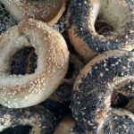 sesame and poppyseed bagels on top of more bagels.