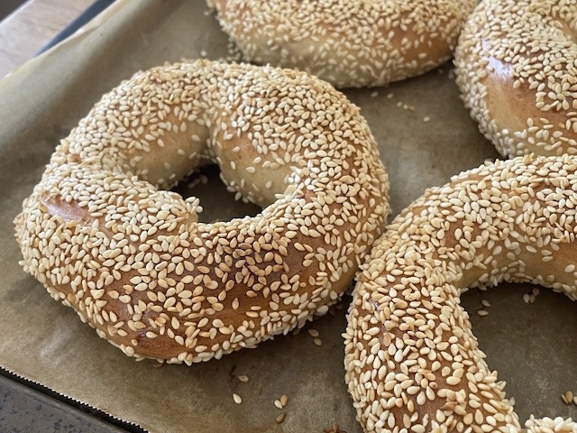 A close up of a tray of sesame bagels