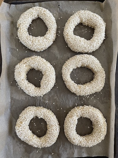 raw bagels topped with sesame seeds.