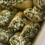 tofu and dill stuffed shells, ready to be baked