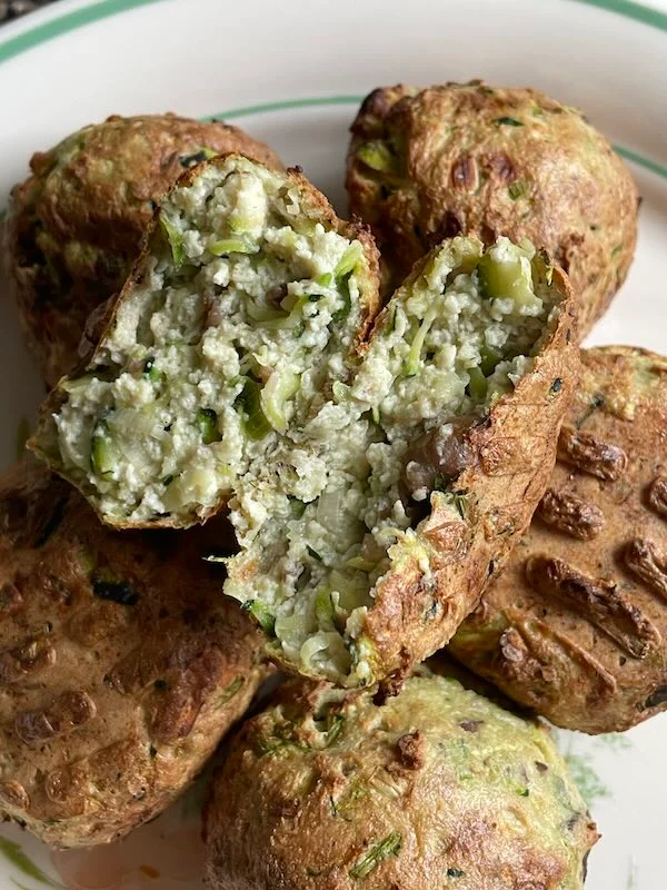 tofu balls made with egg. one tofu ball is split open to reveal texture.