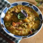 a bowl of rainbow dal with chard, carrots and peppers