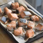 Maple baked salmon on a baking tray after cooking in the oven.