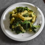 Vegan pasta with kale and edamame sauce on a plate.