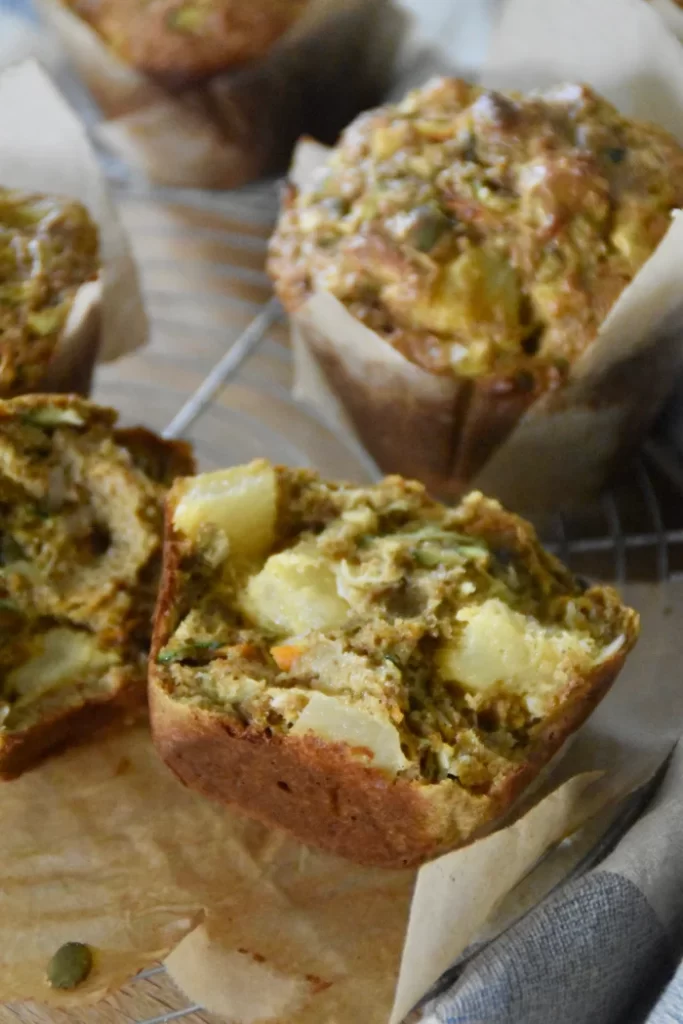 A crumb shot of pineapple morning glory muffin showing chunks of pineapple in the muffin.